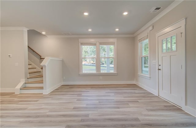 entryway featuring visible vents, ornamental molding, stairs, and light wood-style flooring