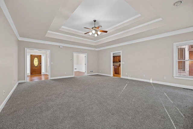 interior space featuring crown molding, carpet floors, a raised ceiling, and ceiling fan