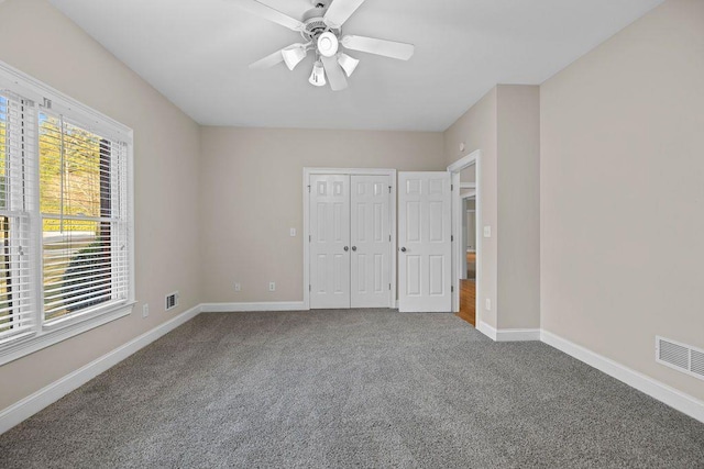 unfurnished bedroom featuring carpet floors and ceiling fan