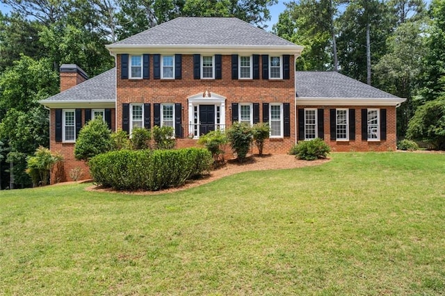 4546 Graywood Trce, Peachtree Corners, GA 30092 - colonial home with a front lawn, brick siding, roof with shingles, and a chimney