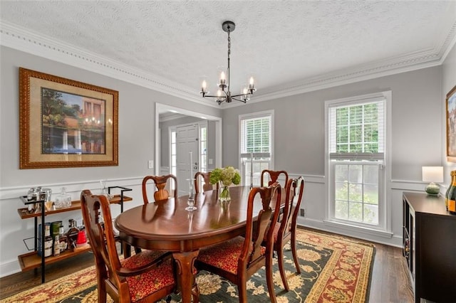 4546 Graywood Trce, Peachtree Corners, GA 30092 - dining space featuring a chandelier, crown molding, wainscoting, a decorative wall, and a textured ceiling