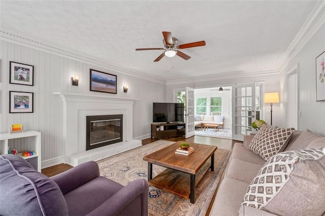 4546 Graywood Trce, Peachtree Corners, GA 30092 - living area with ceiling fan, ornamental molding, wood finished floors, a glass covered fireplace, and a textured ceiling