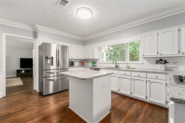 4546 Graywood Trce, Peachtree Corners, GA 30092 - kitchen featuring stainless steel appliances, white cabinetry, backsplash, crown molding, and a center island