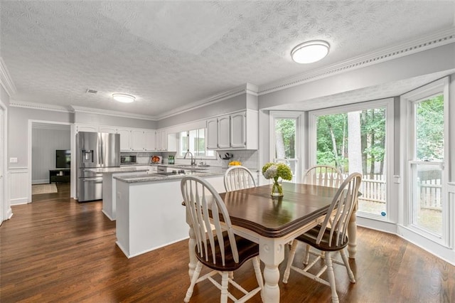 4546 Graywood Trce, Peachtree Corners, GA 30092 - dining space featuring healthy amount of natural light, dark wood-style floors, crown molding, and a textured ceiling