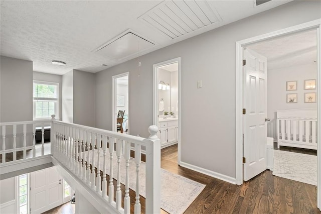 4546 Graywood Trce, Peachtree Corners, GA 30092 - hallway with attic access, an upstairs landing, and wood finished floors