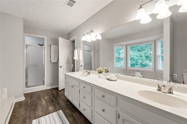 4546 Graywood Trce, Peachtree Corners, GA 30092 - full bathroom featuring a shower stall, double vanity, and wood finished floors