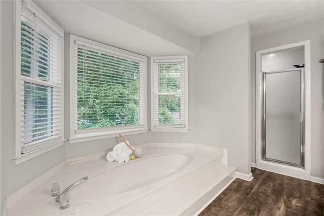 4546 Graywood Trce, Peachtree Corners, GA 30092 - bathroom featuring a stall shower, a bath, and wood finished floors