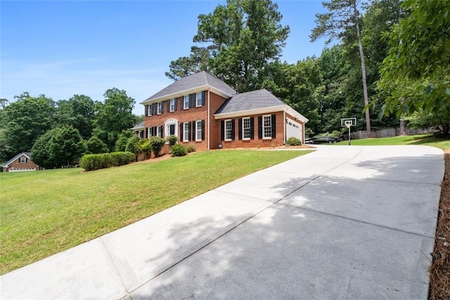 4546 Graywood Trce, Peachtree Corners, GA 30092 - colonial home featuring an attached garage, driveway, a front lawn, and brick siding