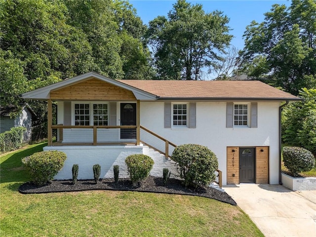 1409 Georgia Ave, East Point, GA 30344 - view of front of property with a front yard, a porch, driveway, and stucco siding