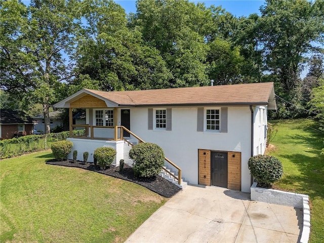 1409 Georgia Ave, East Point, GA 30344 - view of front of house with a front yard, stucco siding, covered porch, and driveway