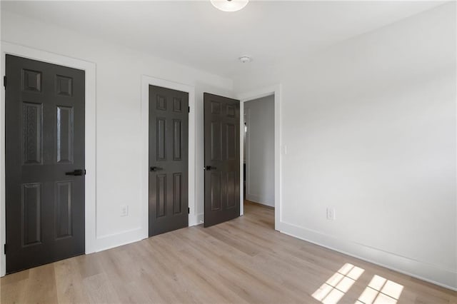 1409 Georgia Ave, East Point, GA 30344 - unfurnished bedroom featuring light wood finished floors and baseboards