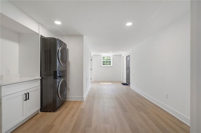 1409 Georgia Ave, East Point, GA 30344 - laundry room featuring stacked washer and clothes dryer, light wood-type flooring, and recessed lighting