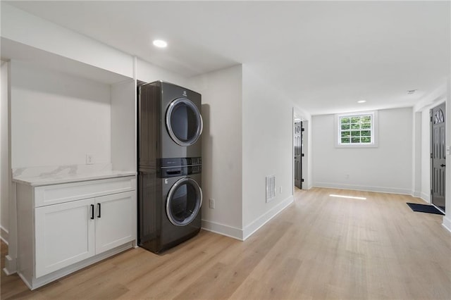 1409 Georgia Ave, East Point, GA 30344 - laundry area featuring stacked washer and clothes dryer, light wood-style flooring, and recessed lighting