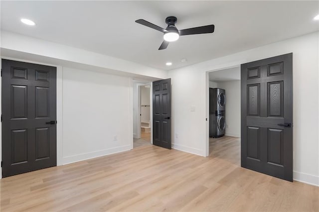 1409 Georgia Ave, East Point, GA 30344 - unfurnished bedroom featuring stacked washer / drying machine, a spacious closet, recessed lighting, light wood finished floors, and a closet