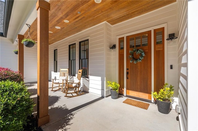 view of exterior entry with covered porch