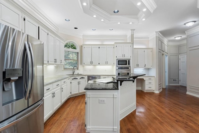 940 Waters Reach Ct, Alpharetta, GA 30022 - kitchen with white cabinetry, a kitchen breakfast bar, dark stone counters, a sink, and appliances with stainless steel finishes