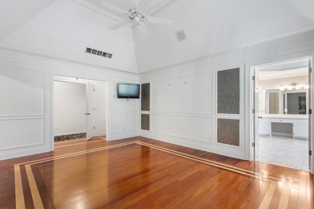 940 Waters Reach Ct, Alpharetta, GA 30022 - unfurnished room with high vaulted ceiling, a decorative wall, visible vents, a ceiling fan, and wood-type flooring