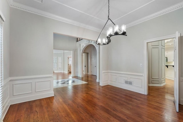 940 Waters Reach Ct, Alpharetta, GA 30022 - unfurnished dining area with crown molding, a chandelier, wood finished floors, visible vents, and arched walkways