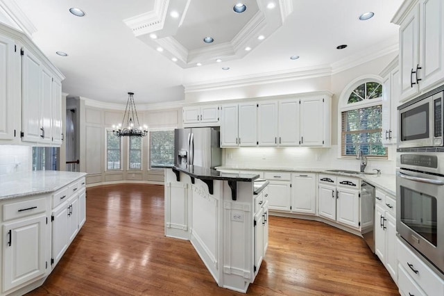940 Waters Reach Ct, Alpharetta, GA 30022 - kitchen with white cabinets, an inviting chandelier, crown molding, and appliances with stainless steel finishes