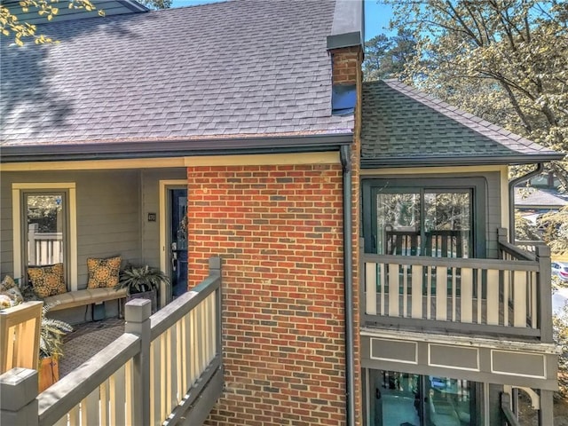 470 Ansley Walk Ter NE, Atlanta, GA 30309 - view of side of property with roof with shingles, brick siding, and a balcony