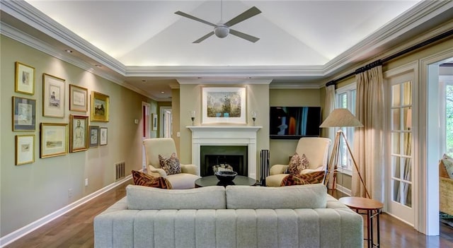 470 Ansley Walk Ter NE, Atlanta, GA 30309 - living area featuring a ceiling fan, a fireplace, dark wood-style flooring, a tray ceiling, and crown molding