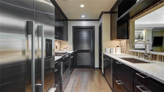 470 Ansley Walk Ter NE, Atlanta, GA 30309 - kitchen featuring stainless steel appliances, ornamental molding, light wood-type flooring, light stone counters, and recessed lighting