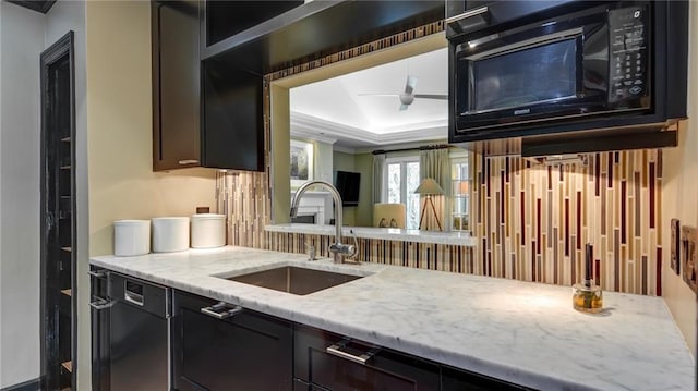 470 Ansley Walk Ter NE, Atlanta, GA 30309 - kitchen with black microwave, a tray ceiling, light stone counters, dishwashing machine, and a ceiling fan