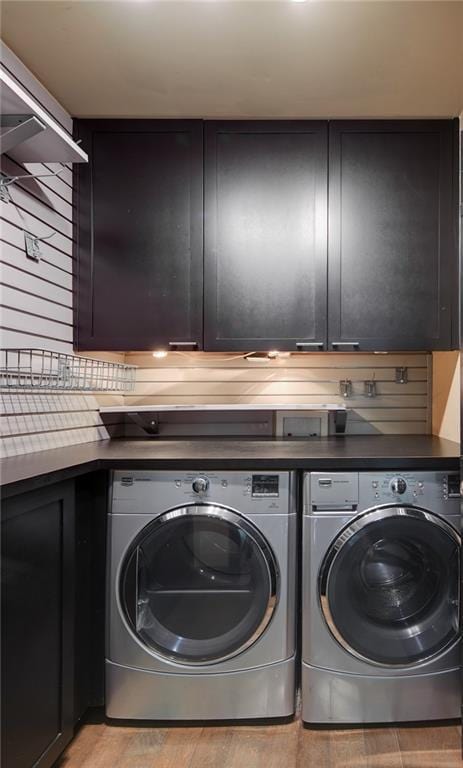 470 Ansley Walk Ter NE, Atlanta, GA 30309 - laundry area with cabinet space, washer and dryer, and light wood-style floors
