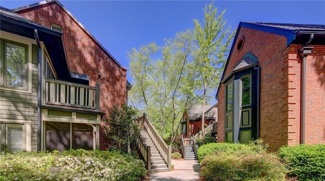 470 Ansley Walk Ter NE, Atlanta, GA 30309 - view of property exterior featuring stairway, a balcony, and brick siding