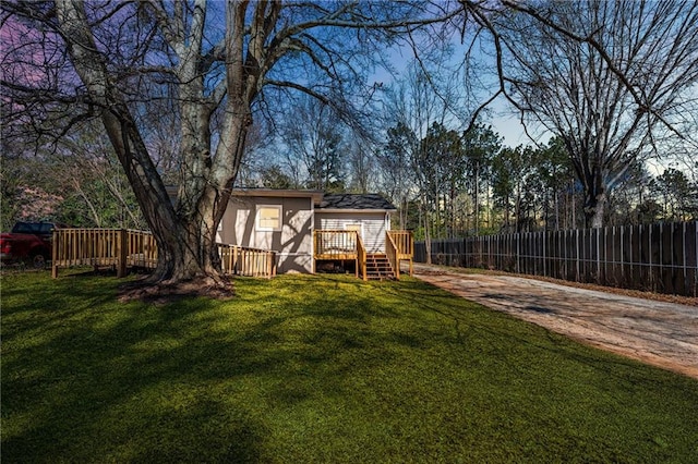 view of yard with a deck and fence