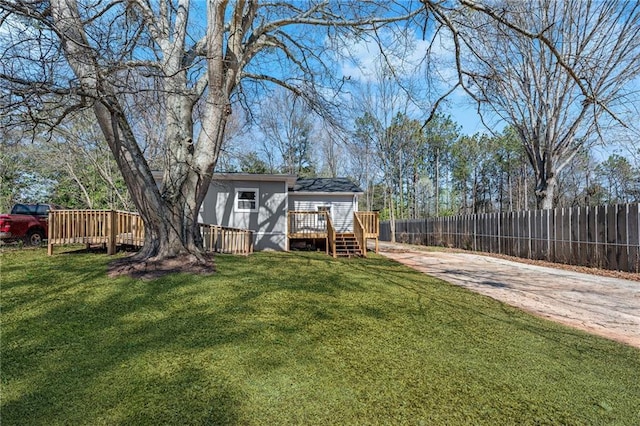 view of yard with a deck and fence