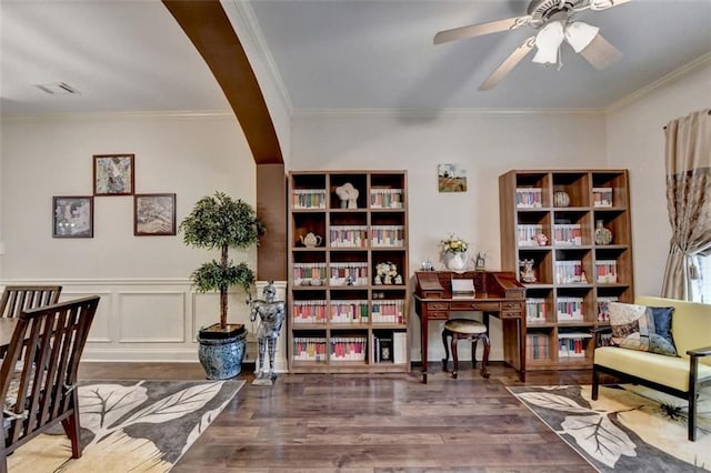 2837 Peachstone Ct, Lawrenceville, GA 30043 - living area with wood finished floors, crown molding, ceiling fan, and a wainscoted wall