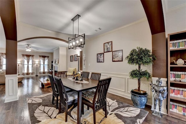 2837 Peachstone Ct, Lawrenceville, GA 30043 - dining room with arched walkways, wood finished floors, ceiling fan, crown molding, and wainscoting