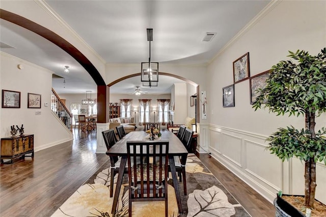 2837 Peachstone Ct, Lawrenceville, GA 30043 - dining space with arched walkways, wood finished floors, ceiling fan, ornamental molding, and a wainscoted wall
