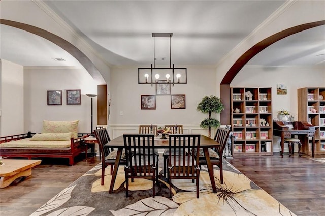 2837 Peachstone Ct, Lawrenceville, GA 30043 - dining area with arched walkways, wood finished floors, crown molding, and a chandelier