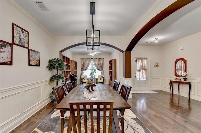 2837 Peachstone Ct, Lawrenceville, GA 30043 - dining area featuring arched walkways, wood finished floors, a ceiling fan, ornamental molding, and a decorative wall