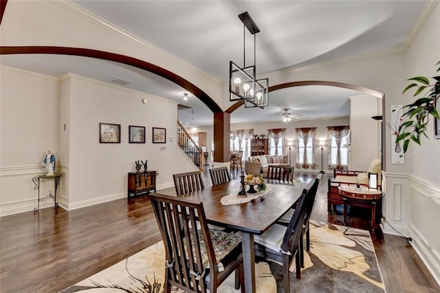 2837 Peachstone Ct, Lawrenceville, GA 30043 - dining area with arched walkways, a ceiling fan, wood finished floors, crown molding, and stairs