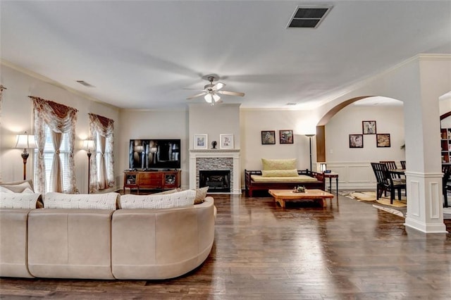 2837 Peachstone Ct, Lawrenceville, GA 30043 - living area featuring ceiling fan, arched walkways, crown molding, wood finished floors, and a stone fireplace