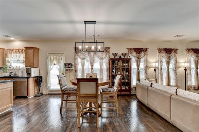 2837 Peachstone Ct, Lawrenceville, GA 30043 - dining room with a chandelier, ornamental molding, and dark wood-type flooring