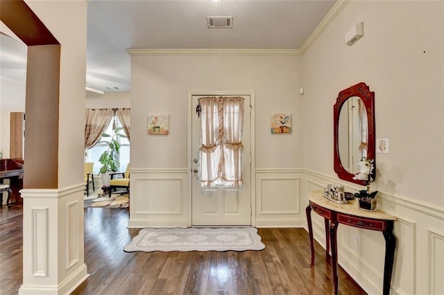 2837 Peachstone Ct, Lawrenceville, GA 30043 - entrance foyer featuring decorative columns, crown molding, wood finished floors, a wainscoted wall, and a decorative wall