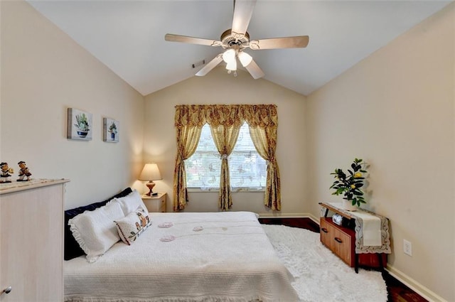 2837 Peachstone Ct, Lawrenceville, GA 30043 - bedroom with lofted ceiling, baseboards, wood finished floors, and a ceiling fan