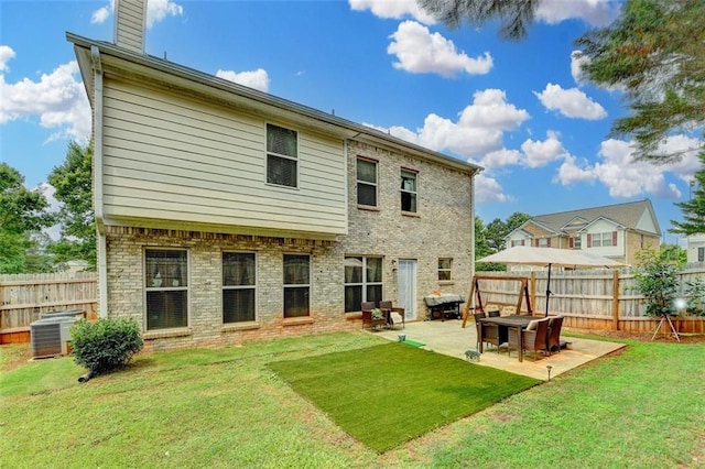 2837 Peachstone Ct, Lawrenceville, GA 30043 - back of house featuring central air condition unit, a patio, and a chimney