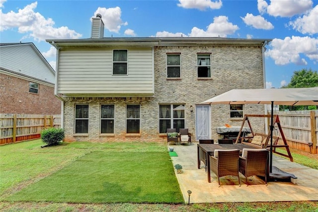 2837 Peachstone Ct, Lawrenceville, GA 30043 - rear view of property featuring a patio area, a chimney, and brick siding