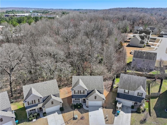 drone / aerial view with a forest view and a residential view