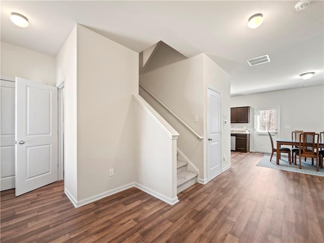 interior space featuring stairs, wood finished floors, visible vents, and baseboards