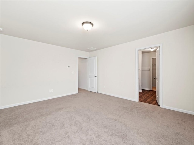 carpeted spare room with baseboards