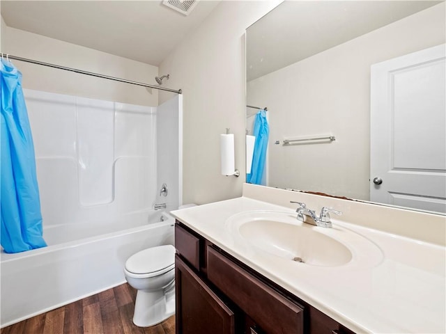 full bath with toilet, wood finished floors, vanity, visible vents, and shower / tub combo with curtain