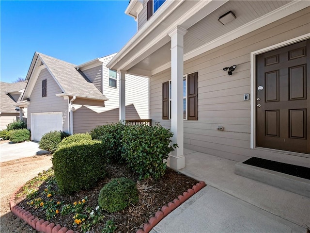 property entrance with an attached garage and a porch