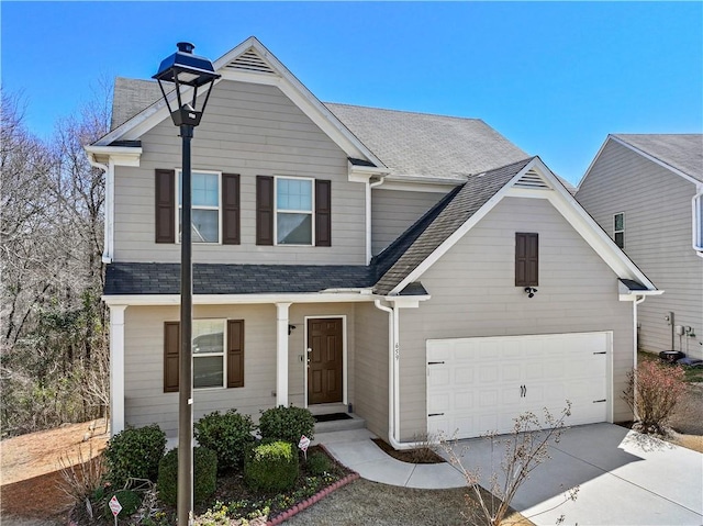 view of front of property with a shingled roof and concrete driveway