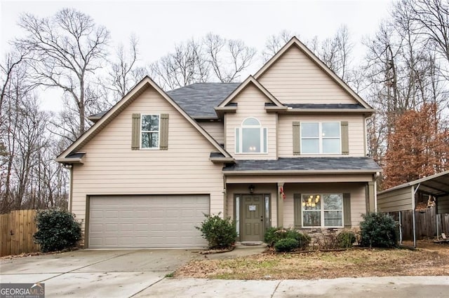 view of front of home featuring concrete driveway, a garage, and fence